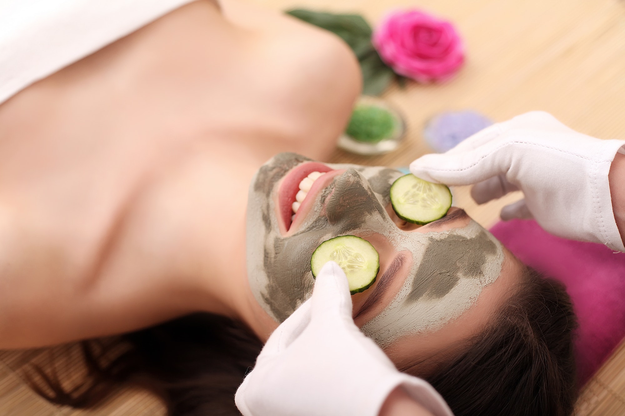 Girl with facial mask lying in beauty health spa center