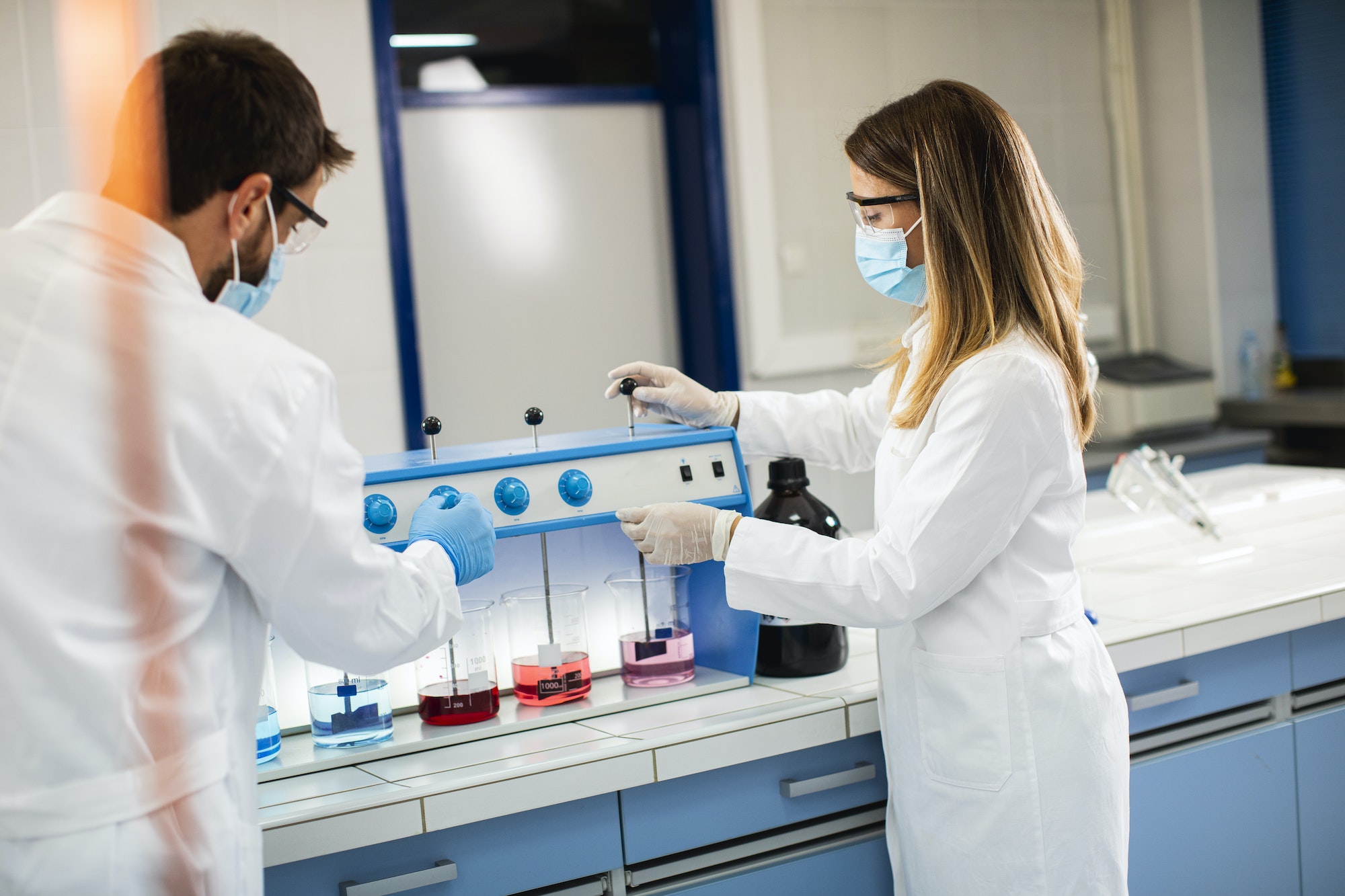 Group of young researchers analyzing chemical data in the flocculator at laboratory