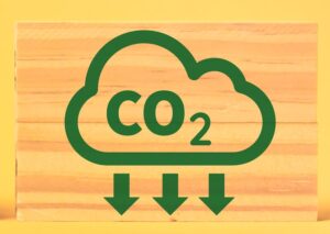 Reducing carbon footprint concept with icons on wooden blocks.